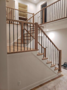 Stairway With White Oak Wood And Iron Balusters